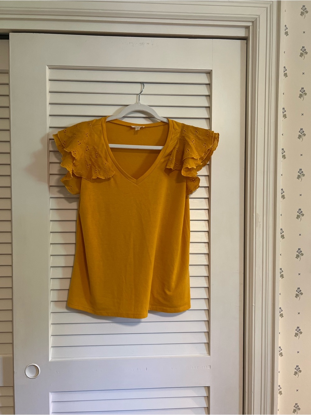 Women’s M golden colored v neck with eyelet flutter sleeves.